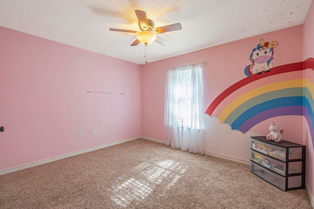 carpeted empty room featuring a textured ceiling and ceiling fan