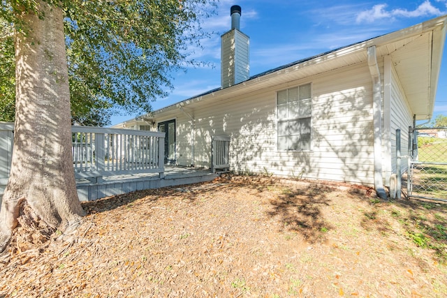 back of property featuring a wooden deck