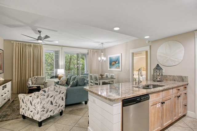 kitchen featuring stainless steel dishwasher, light brown cabinets, sink, and light tile patterned floors