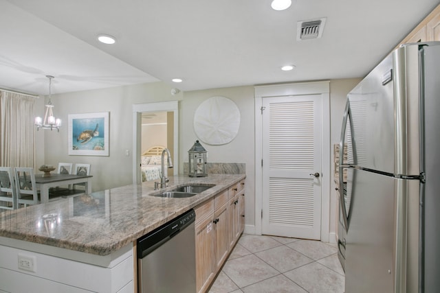 kitchen featuring light tile patterned flooring, stainless steel appliances, light brown cabinetry, light stone countertops, and sink