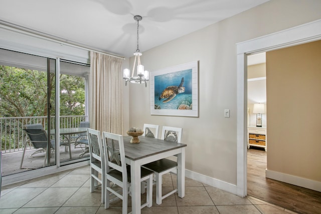 dining area featuring a notable chandelier and light tile patterned floors