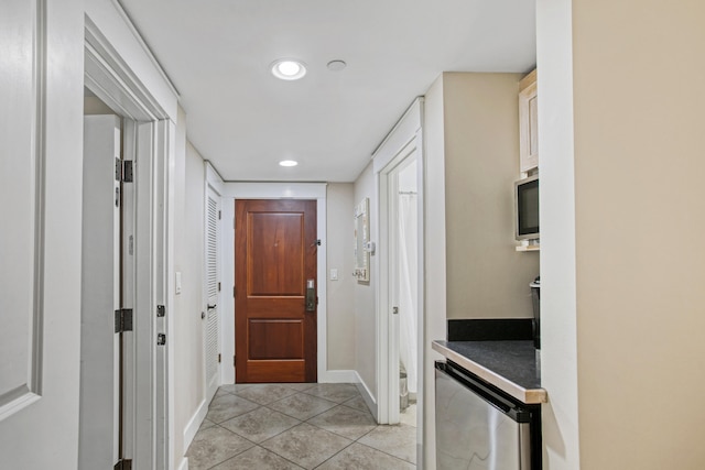 corridor featuring light tile patterned flooring