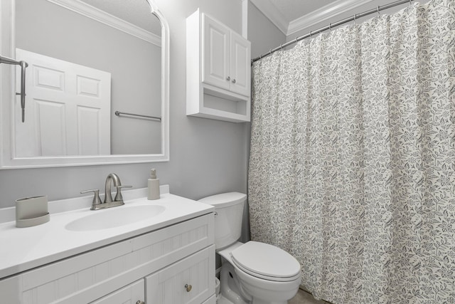 bathroom featuring vanity, toilet, ornamental molding, and a textured ceiling