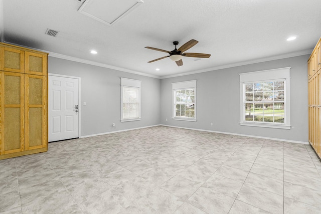 spare room featuring crown molding, ceiling fan, and a healthy amount of sunlight