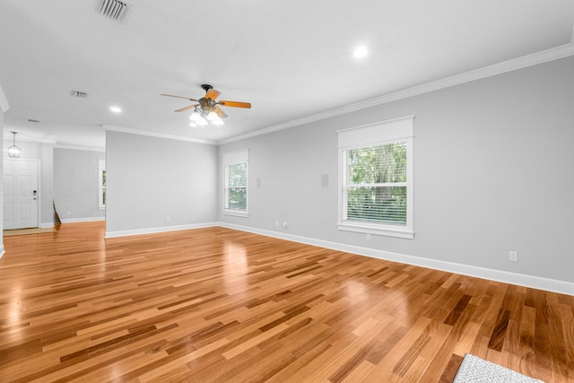 empty room featuring light hardwood / wood-style floors, ceiling fan, and crown molding