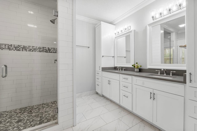 bathroom with a shower with door, vanity, a textured ceiling, and ornamental molding