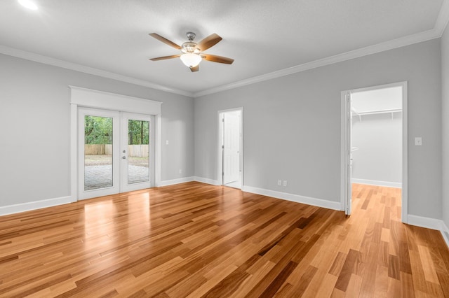 spare room with french doors, light hardwood / wood-style flooring, ceiling fan, and ornamental molding