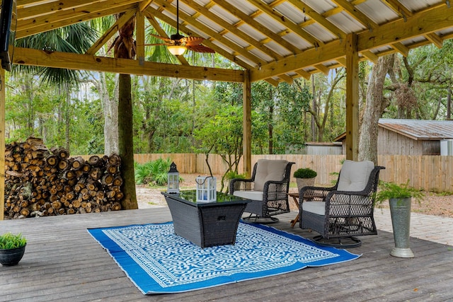 wooden terrace featuring a gazebo and ceiling fan