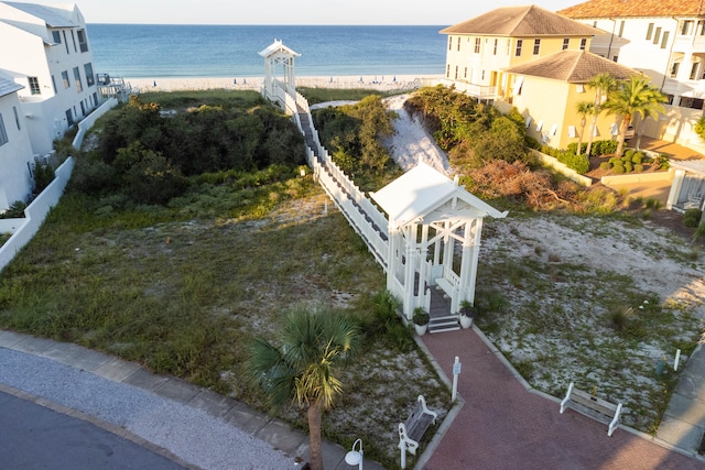 birds eye view of property with a water view and a beach view