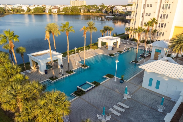 view of swimming pool featuring a water view and a patio