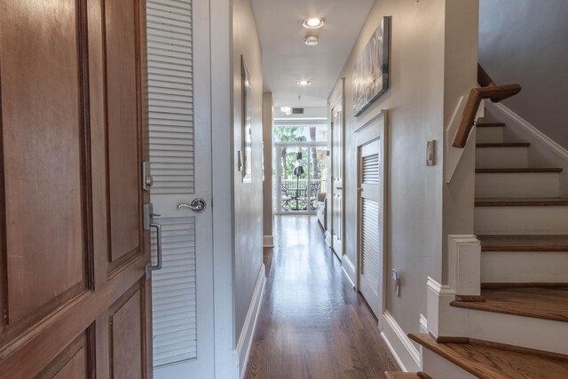 105 Carillon Market St Ste 302, Panama City Beach, FL 32413 - hallway featuring stairs, dark wood-type flooring, baseboards, and recessed lighting