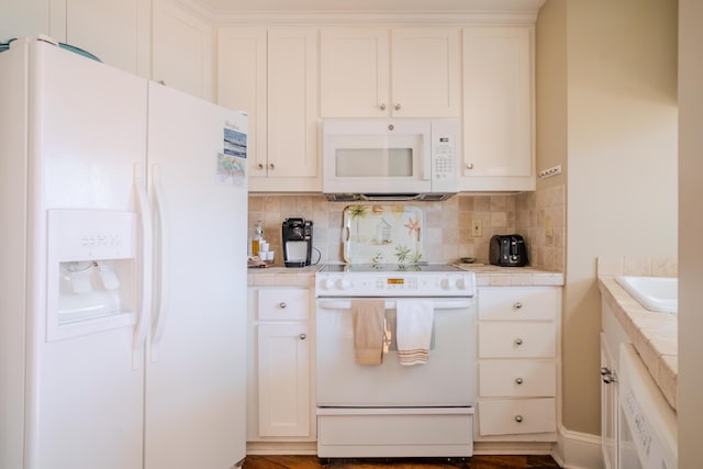 kitchen with white appliances, tasteful backsplash, white cabinetry, and sink