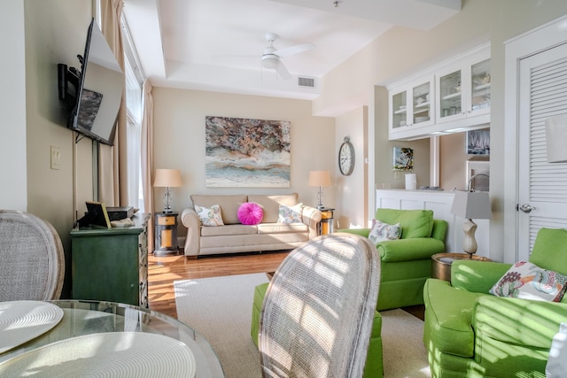 living room featuring ceiling fan and light hardwood / wood-style flooring