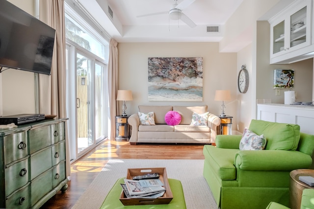 living room featuring hardwood / wood-style flooring and ceiling fan