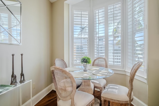 105 Carillon Market St Ste 302, Panama City Beach, FL 32413 - dining space featuring baseboards and wood finished floors