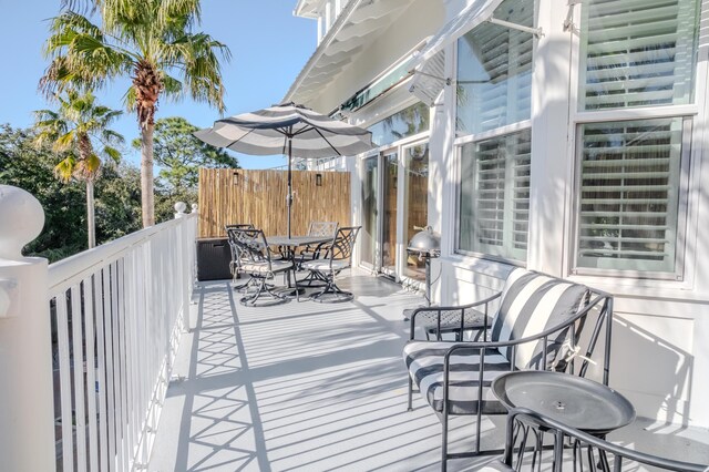105 Carillon Market St Ste 302, Panama City Beach, FL 32413 - wooden terrace featuring outdoor dining area