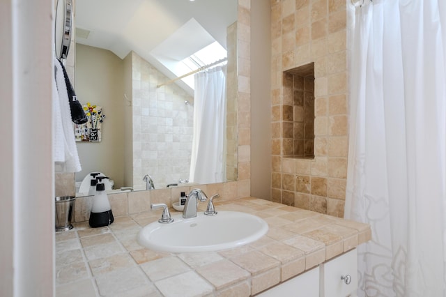 bathroom featuring vanity and tile walls