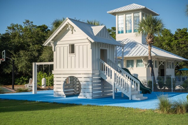 105 Carillon Market St Ste 302, Panama City Beach, FL 32413 - back of property with a standing seam roof, board and batten siding, metal roof, and a yard