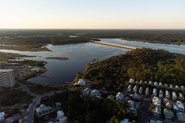 aerial view at dusk featuring a water view