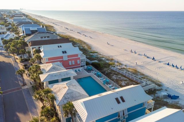 aerial view with a water view and a beach view