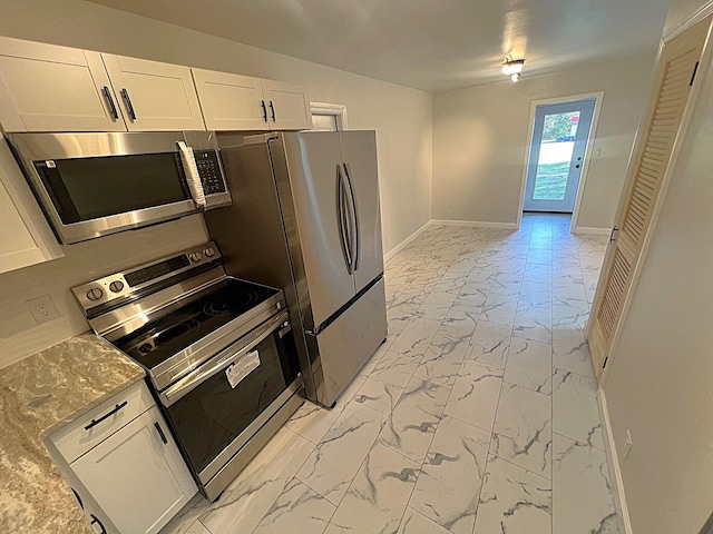 kitchen featuring light stone countertops, white cabinets, and appliances with stainless steel finishes