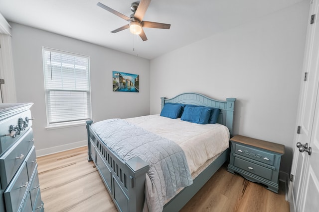 bedroom with ceiling fan and light hardwood / wood-style flooring