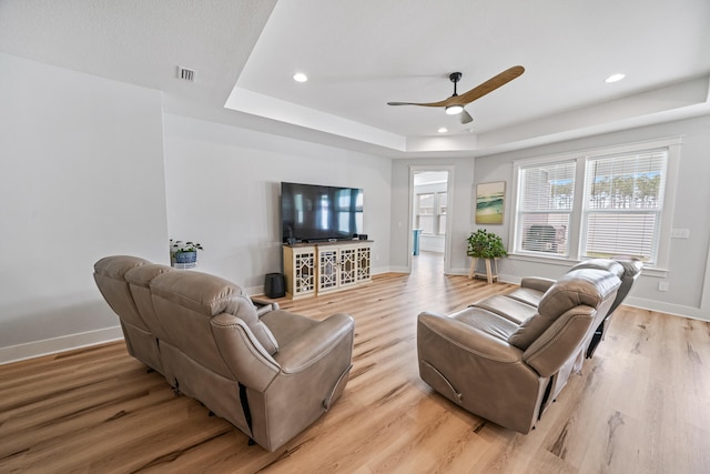 living room featuring light hardwood / wood-style flooring and ceiling fan