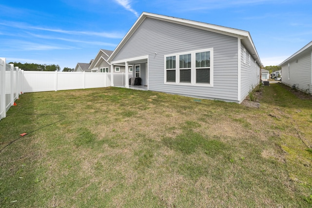 back of house with a yard and a patio area