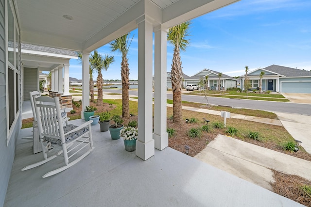 view of patio / terrace featuring a porch and a garage