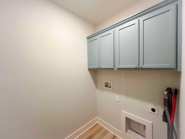 clothes washing area with cabinets, hookup for a washing machine, hookup for an electric dryer, and light hardwood / wood-style flooring