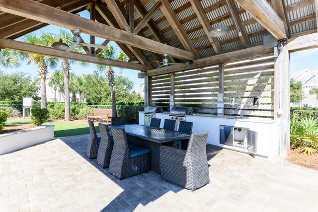 view of patio with grilling area, ceiling fan, exterior kitchen, and a gazebo