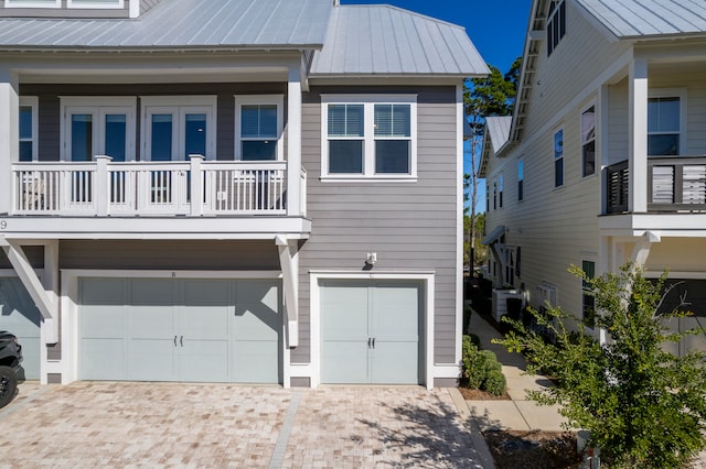 exterior space featuring a garage and a balcony