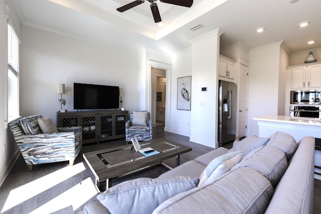 living room with dark hardwood / wood-style flooring, ceiling fan, and crown molding