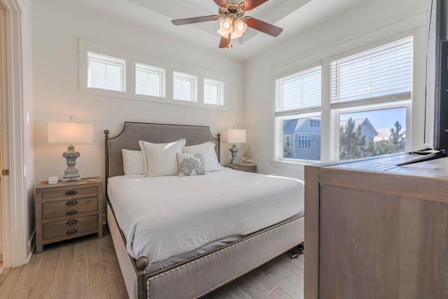 bedroom with ceiling fan and light wood-type flooring