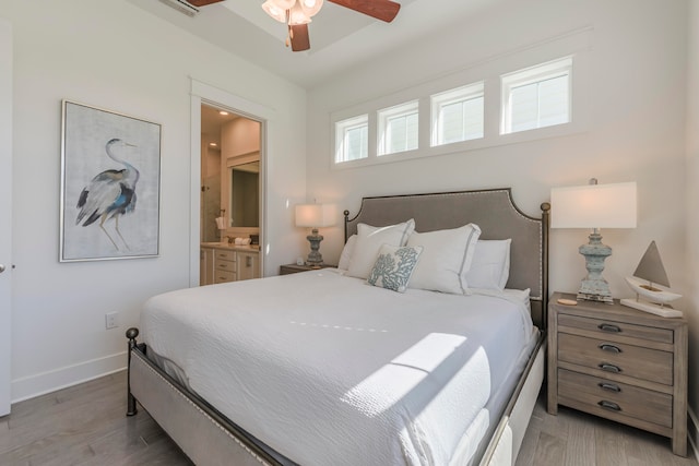 bedroom featuring light wood-type flooring, ceiling fan, and ensuite bath