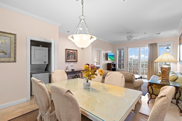 10343 E County Highway 30a Unit 312D, Inlet Beach, FL 32461 - dining space with stacked washer and clothes dryer, crown molding, baseboards, a ceiling fan, and light tile patterned flooring