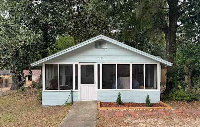 bungalow-style home with a sunroom