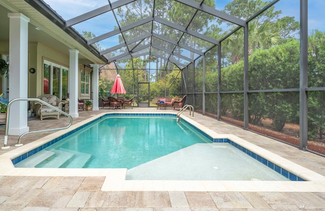 view of swimming pool with a lanai and a patio