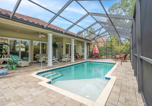 view of pool featuring a lanai, ceiling fan, and a patio