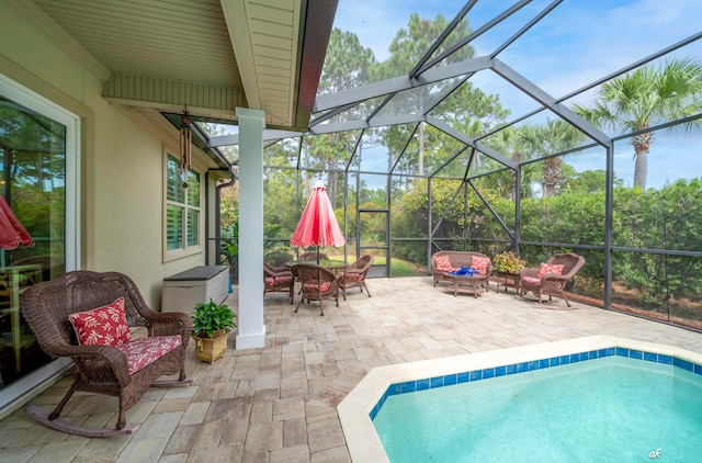 view of pool with a patio area and a lanai