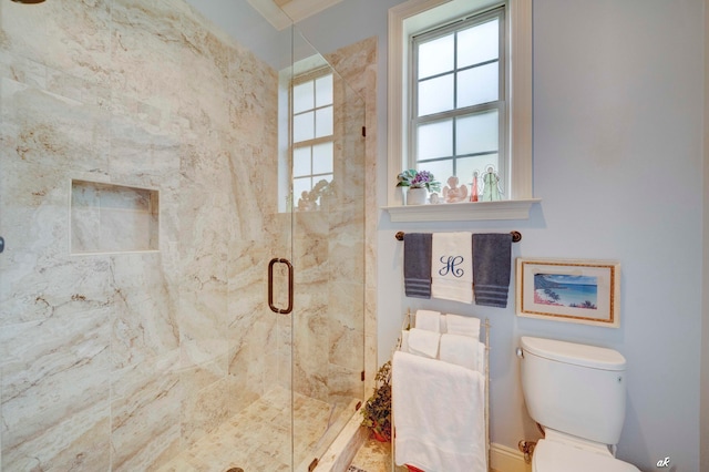 bathroom with toilet, an enclosed shower, and ornamental molding