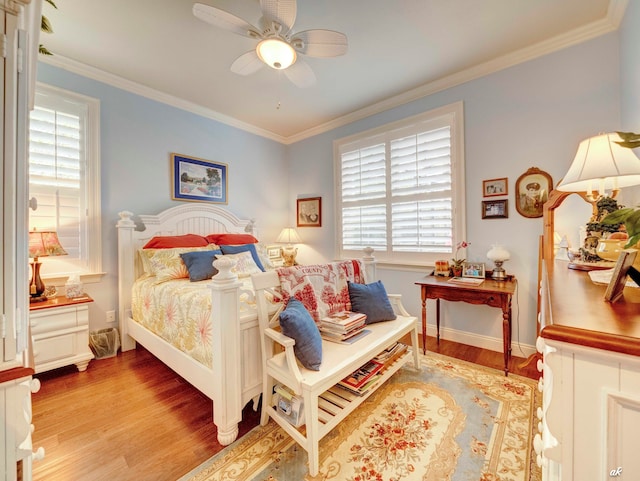 bedroom featuring ceiling fan, crown molding, and light hardwood / wood-style floors