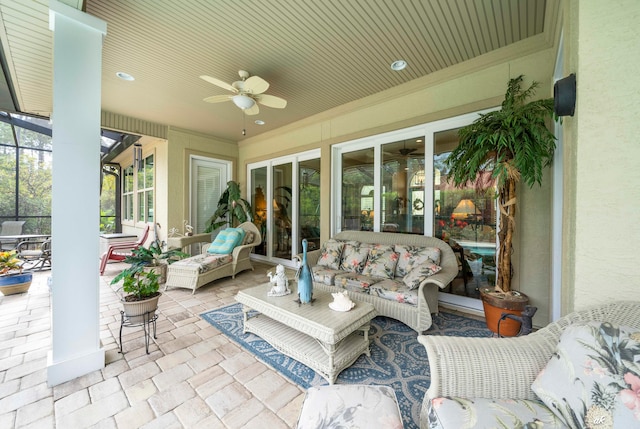 sunroom / solarium featuring ceiling fan