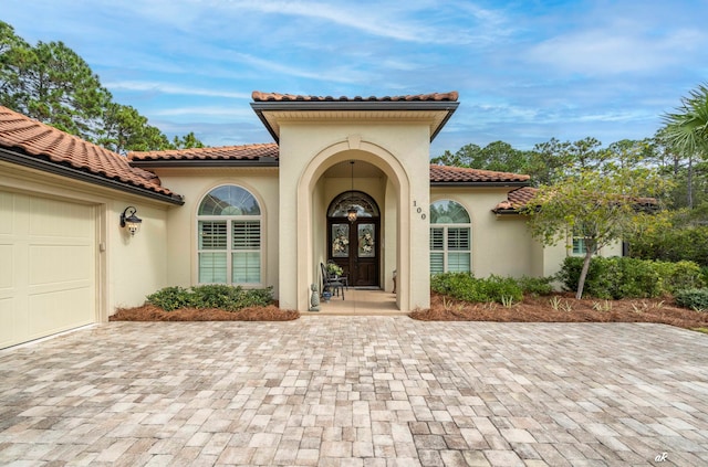 view of exterior entry with a garage