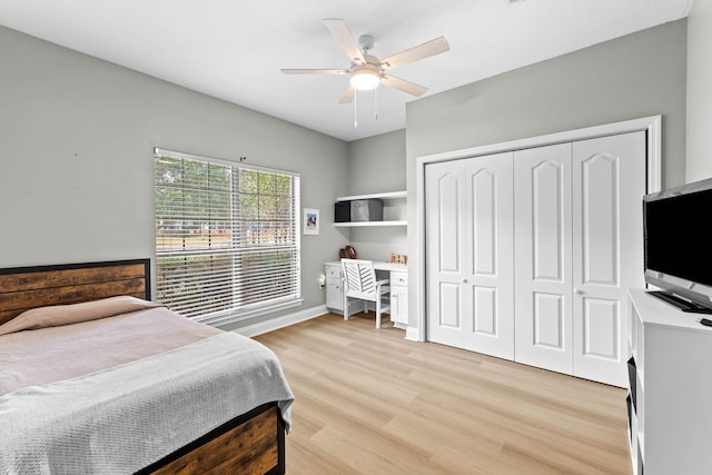 bedroom featuring ceiling fan, light wood-type flooring, and a closet