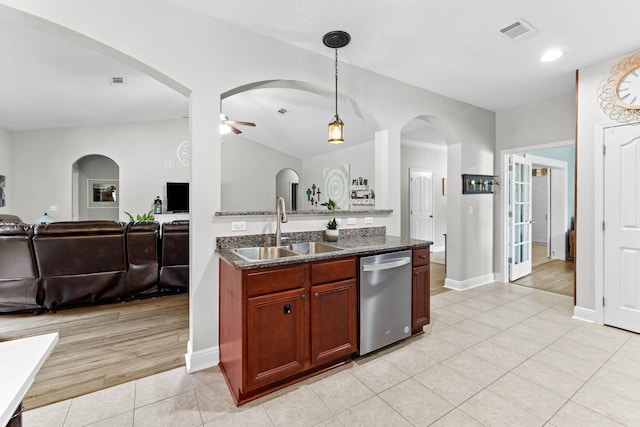 kitchen featuring light wood-type flooring, ceiling fan, sink, pendant lighting, and dishwasher