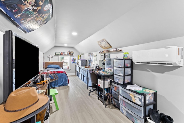 bedroom featuring a wall mounted AC, light hardwood / wood-style floors, and lofted ceiling