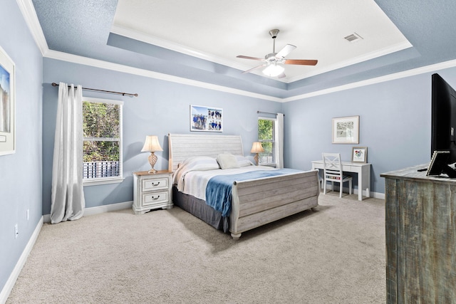 bedroom featuring ceiling fan, a raised ceiling, and multiple windows