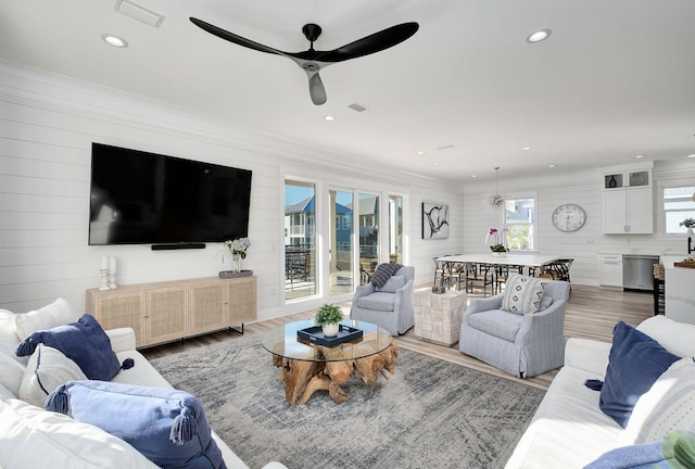 living room with ceiling fan and wood-type flooring