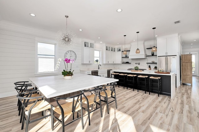 kitchen featuring white cabinets, a center island, and plenty of natural light